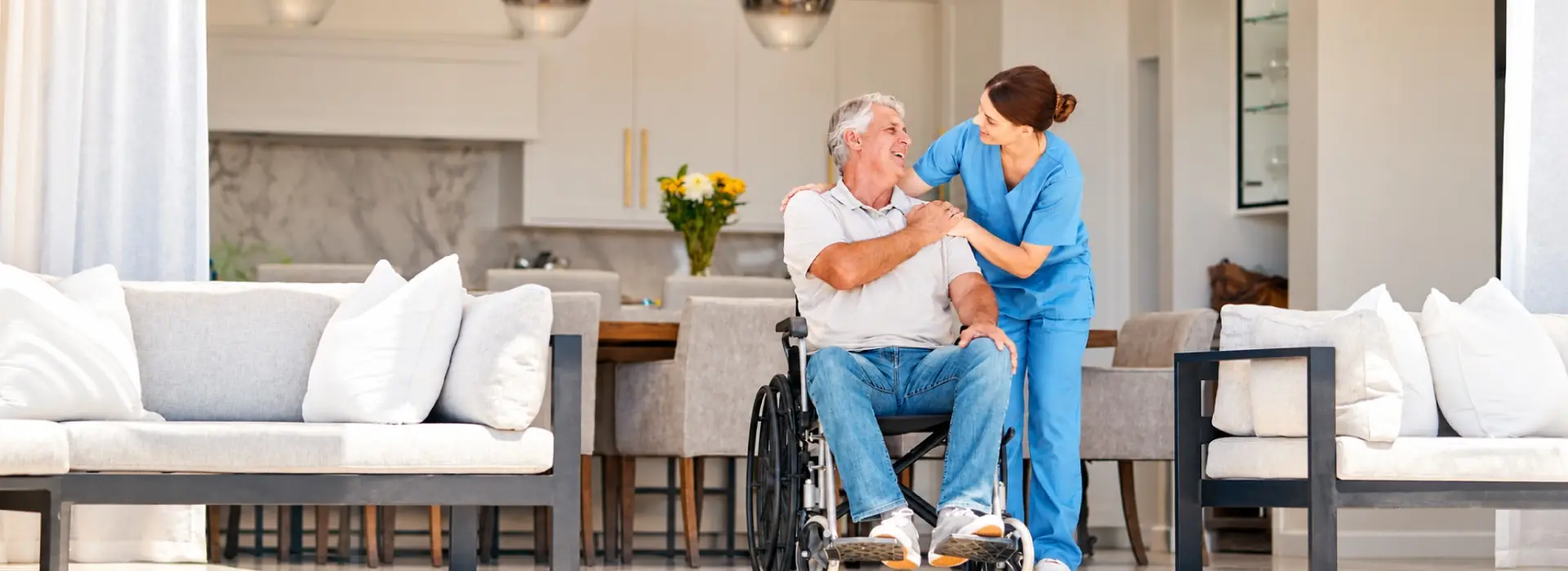 Smiling man in a wheelchair enjoying music at home